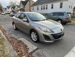 2011 Mazda 3 sedan with 83,000 miles, automatic transmission, silver exterior, parked on a residential street.
