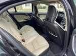Interior view of a 2012 Volvo S60 T5, featuring leather seating and spacious back seat area.