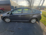 2013 Toyota Prius Plug-In Hybrid parked, showcasing its clean design and well-maintained exterior.