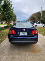 Rear view of a 2006 Volkswagen Jetta TDI in Shadow Blue parked in a driveway.
