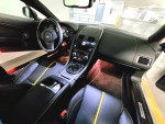 Interior of a 2015 Aston Martin V8 Vantage GT showing sleek design and yellow stitching