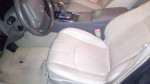 Interior view of a well-maintained 2010 Infiniti G37 with comfortable beige seats.