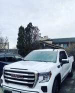 2022 GMC 1500 Sierra 4x4 extended cab in white with roof rack and brand new tires, perfect for contractors.