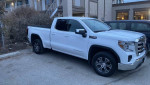 2022 GMC 1500 Sierra 4x4 extended cab with roof rack, white truck parked, local contractor special.