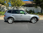 2007 BMW X3 3.0si AWD compact SUV in great condition, with clean title and no leaks, parked on a sunny street.