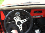 Interior view of a 1968 Chevrolet C10 pickup with a sporty steering wheel and dashboard features.