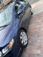 2009 Honda Civic LX in blue with clean exterior, parked on brick street, featuring alloy wheels