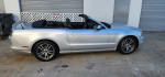 2014 Ford Mustang Convertible in silver color with GT wheels, black leather interior, parked outdoors.