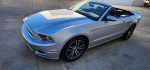 2014 Ford Mustang Convertible in silver with GT wheels, showcasing premium features and stylish design.