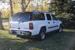 2005 Chevrolet Suburban LS 4WD parked in grassy area with trees in background