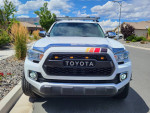Front view of a 2017 Toyota Tacoma 4x4 Extended Cab, showcasing its design and features, parked in a residential area.