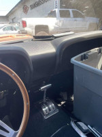 Interior view of a 1970 Ford Mustang with new gear shift and cleaned dashboard.