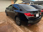 2014 Honda Civic EX-L in black parked, showcasing its sleek design and rear features, for sale at $8,500.