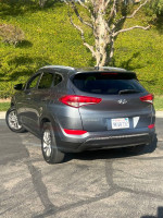 2016 Hyundai Tucson in great mechanical condition, featuring some scratches and a dent, parked outdoors.