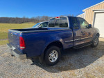 1998 Ford F150 XLT extended cab 4X4, blue truck with minor scratches and new tires.