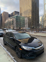 2016 Honda Civic EX-T sedan in excellent condition parked on urban street, showcasing its sleek design and low mileage.